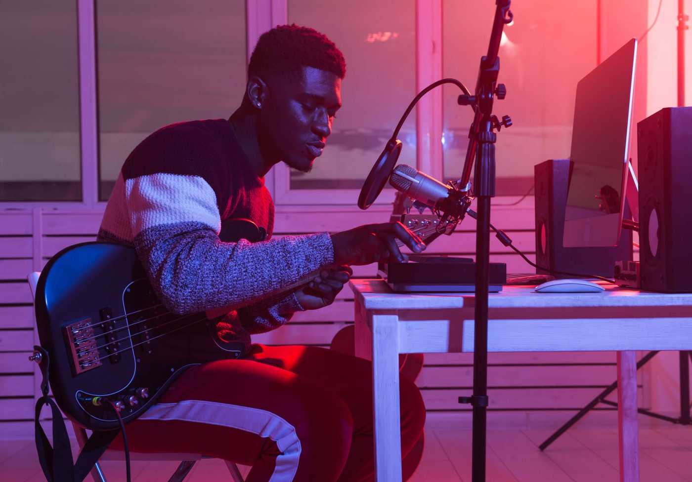 African american professional musician recording synthesizer in digital studio at home, music production technology concept. African american professional musician recording guitar in digital studio at home, music production technology concept