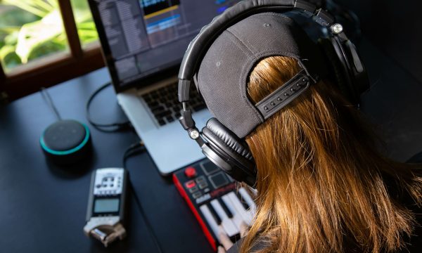 Close up of a female music producer with headphones in her home Close up of a female music producer with headphones in her home